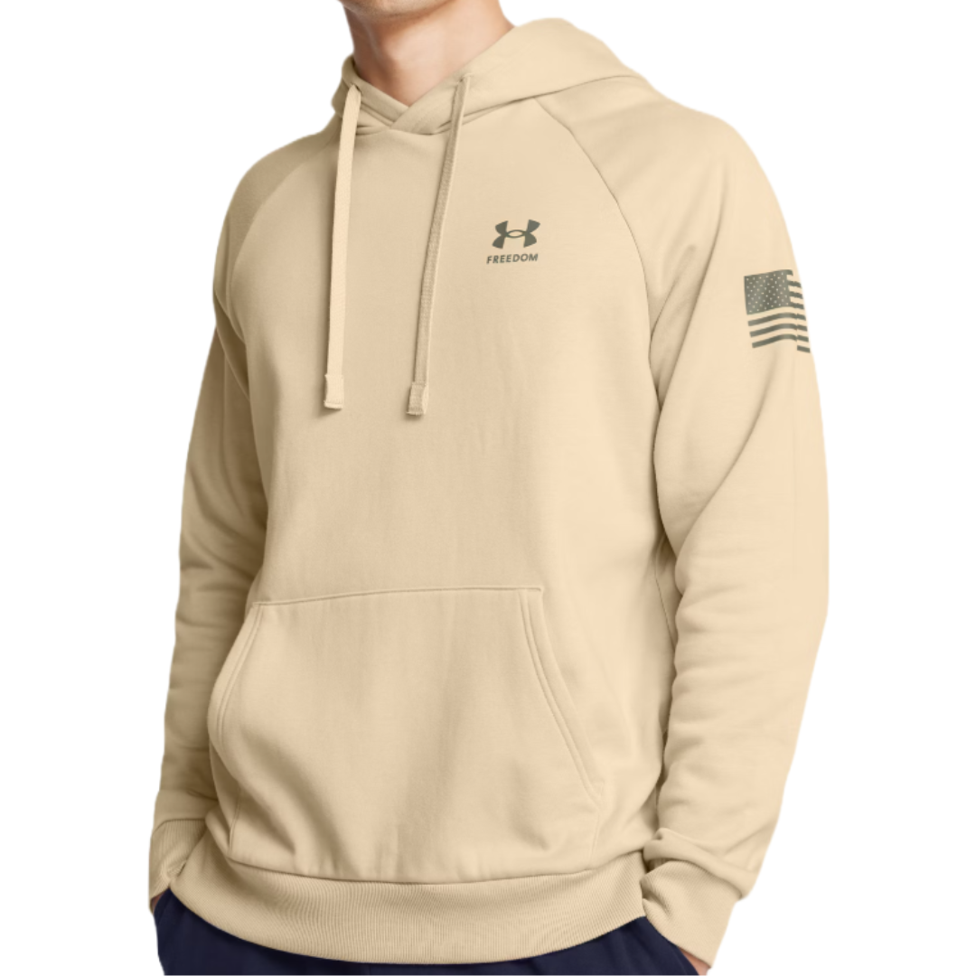 Beige hoodie with a front pocket, featuring the Under Armour logo and the word \“Freedom\“ on the chest, and a stylized American flag on the sleeve.