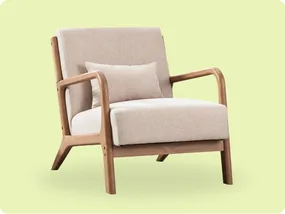 A beige cushioned armchair with wooden frame and arms, featuring a matching lumbar pillow, set against a light green background.