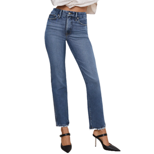 A pair of high-waisted, straight-leg blue jeans with frayed hems, paired with black pointed-toe heels featuring an ankle strap.