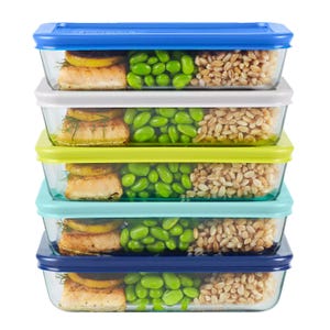 10pc Pyrex Glass Meal Prep Set includes rectangular glass containers with colorful, airtight lids. Each container is filled with salmon, edamame, and grains, neatly stacked in four layers.