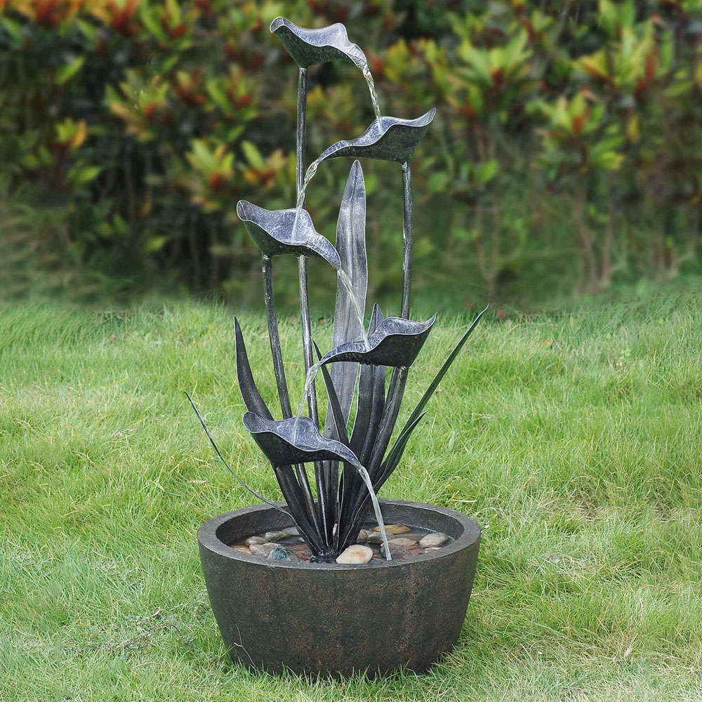 The Hi-Line 36\“ Flower Fountain features a cascading floral design with multiple metal petals through which water flows, set in a round basin with stones for a natural look.