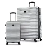 A silver hard-shell luggage set with two pieces, featuring textured surfaces, telescopic handles, and four-wheel spinners for easy maneuvering.