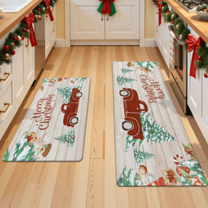 Two Christmas-themed kitchen rugs featuring a red truck and festive decorations on a wooden plank background, with \“Merry Christmas\“ written on them. The kitchen is decorated with garlands and bows.
