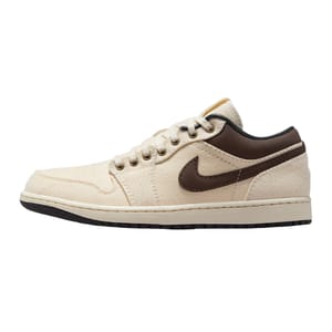 A low-top sneaker in cream color with brown accents and a brown swoosh logo, featuring a lace-up design and a black rubber sole.