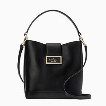 Black leather bucket bag with a magnetic flap closure, featuring an adjustable shoulder strap and a gold-tone Kate Spade logo plaque on the front.