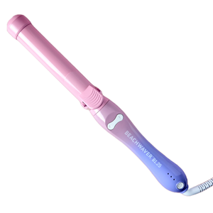 The Beachwaver B1.25 is a pink and purple automatic rotating curling iron designed for creating loose beachy waves. It features a clamp and an ergonomic handle.