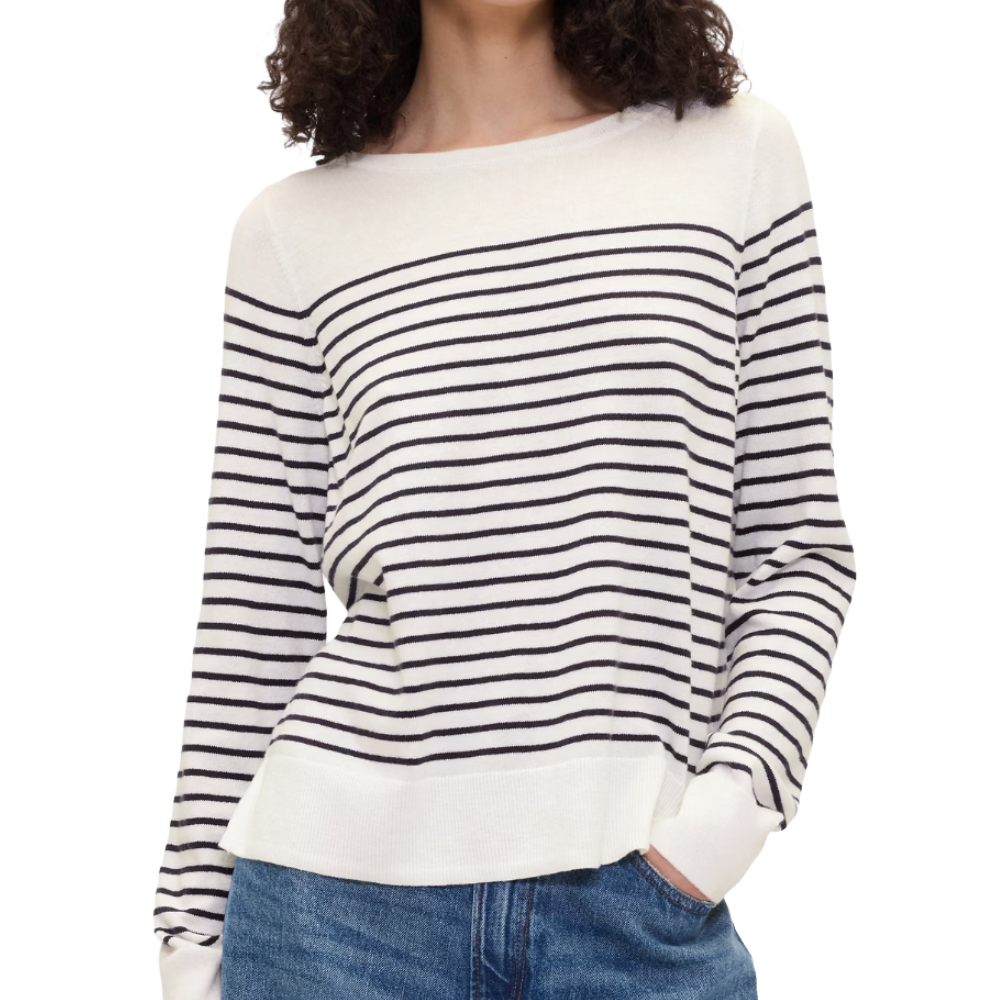 Striped long-sleeve sweater in cream and black, paired with blue jeans.