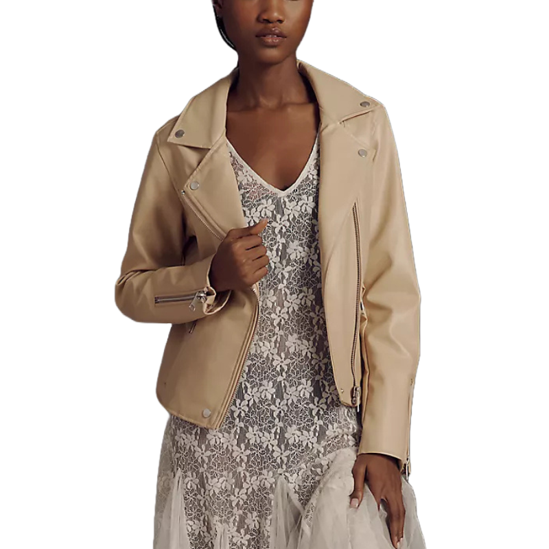 A person wears a beige leather jacket with zip details over a white lace dress.