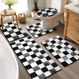 A black and white checkered bathroom set includes rugs, mats, and a toilet seat cover, enhancing the decor with a modern geometric pattern.
