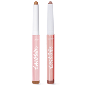 Two Tartelette retractable eyeshadow sticks with pink packaging, featuring light brown and pinkish-brown shades.