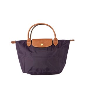 A dark purple tote bag with brown leather handles and a front flap snap closure.