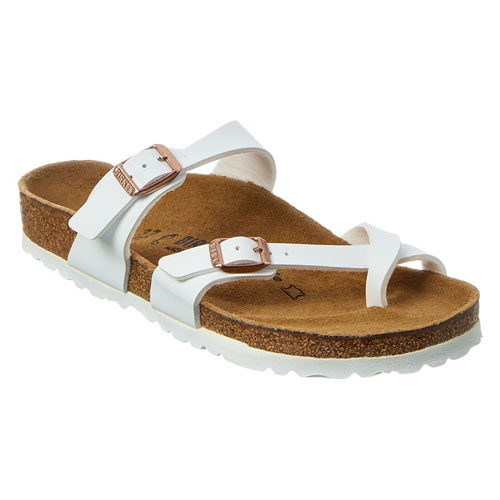 White sandal with a cork footbed, white straps, and a large toe loop, featuring adjustable buckles.