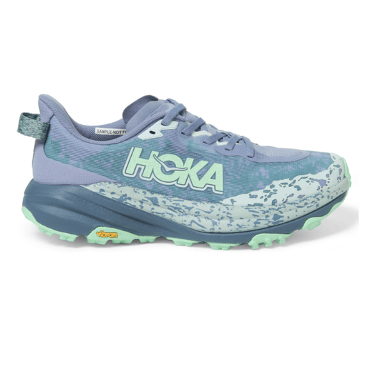 Hoka trail running shoe in lavender and mint green with a Vibram sole and a patterned midsole.
