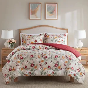 Floral-patterned bedding set on a wooden bed with two matching pillows, accompanied by two white table lamps on side tables, all under two abstract paintings on the wall.