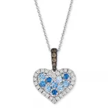 Heart-shaped pendant necklace with blue and white gemstones, set in silver; features a chain and a pavé gemstone bail.