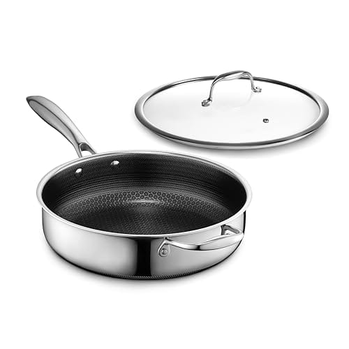 Stainless steel frying pan with a honeycomb-patterned nonstick interior and a matching glass lid.