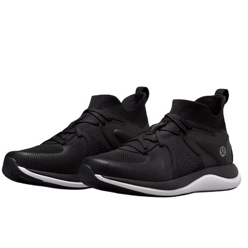 A pair of black athletic sneakers with a white sole, featuring a knitted upper design and lace-up closure.
