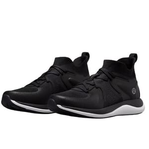 A pair of black athletic sneakers with a white sole, featuring a knitted upper design and lace-up closure.