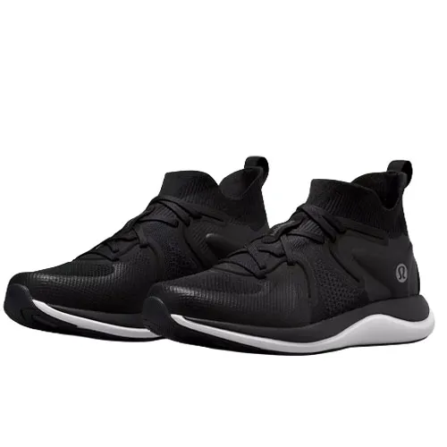 A pair of black athletic sneakers with a white sole, featuring a knitted upper design and lace-up closure.