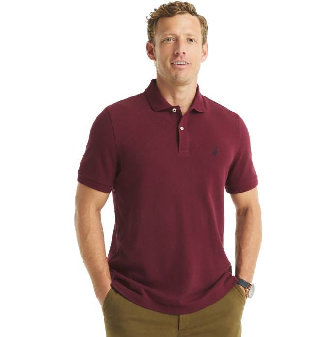 A man is wearing a maroon short-sleeve polo shirt with a small embroidered logo on the chest and olive green pants.
