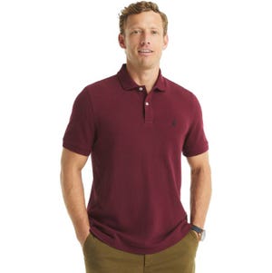 A man is wearing a maroon short-sleeve polo shirt with a small embroidered logo on the chest and olive green pants.