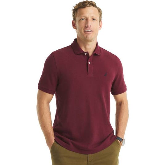 A man is wearing a maroon short-sleeve polo shirt with a small embroidered logo on the chest and olive green pants.