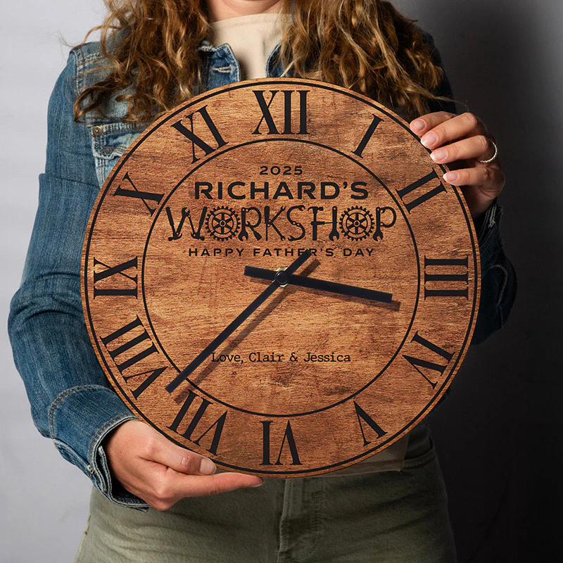 Round wooden clock with Roman numerals, personalized with \“Richard's Workshop\“ and \“Happy Father's Day,\“ along with the message \“Love, Clair & Jessica.\“