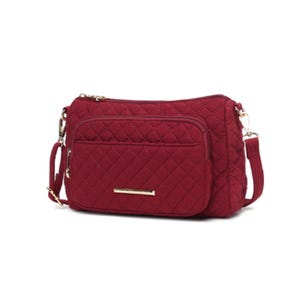 A red quilted crossbody bag with a front zipper pocket and a detachable strap.