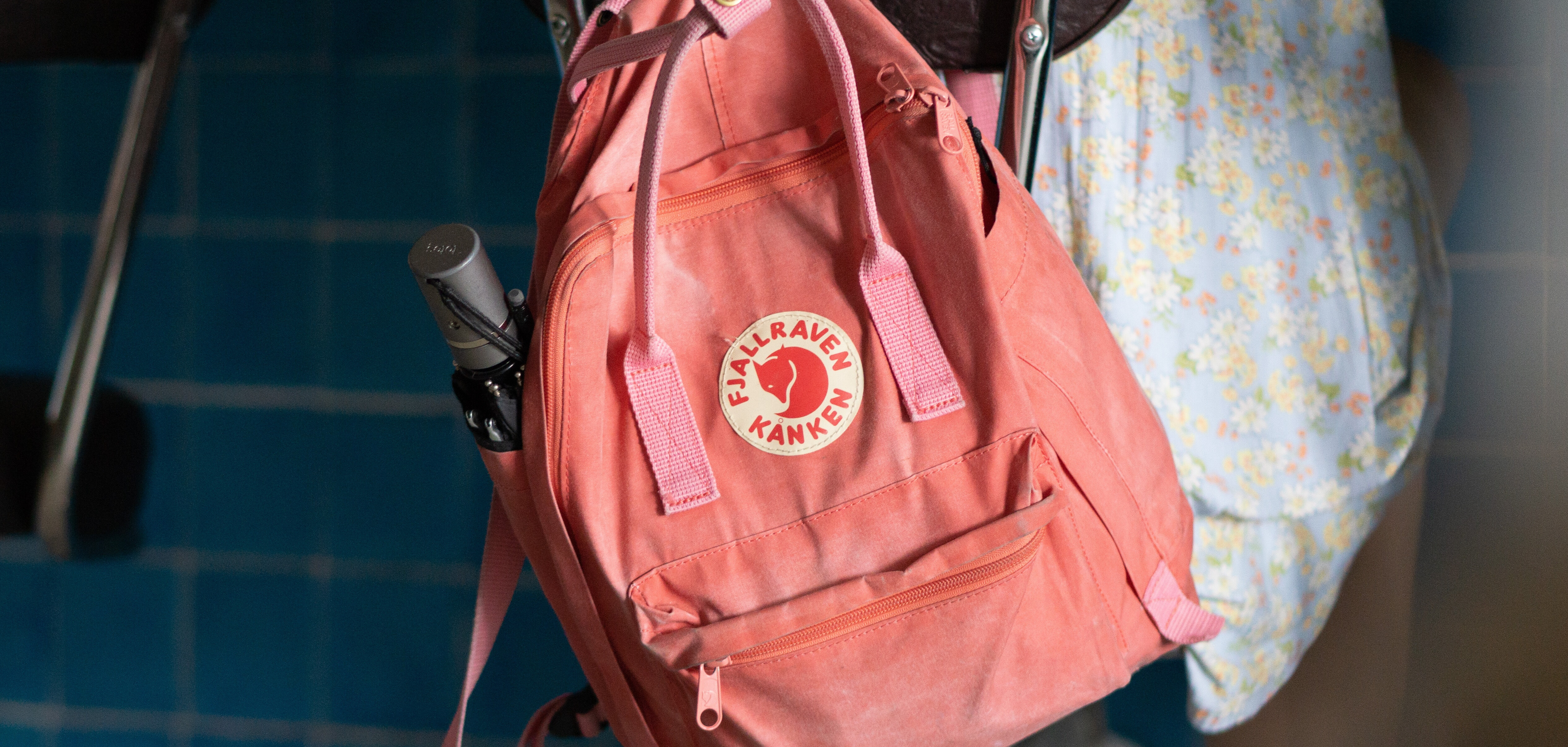 pink backpack hanging on chair