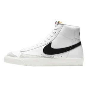 White high-top sneakers with a black Nike swoosh, featuring a leather upper and suede detailing at the toe. They have a classic, retro design with a padded collar and a rubber sole.