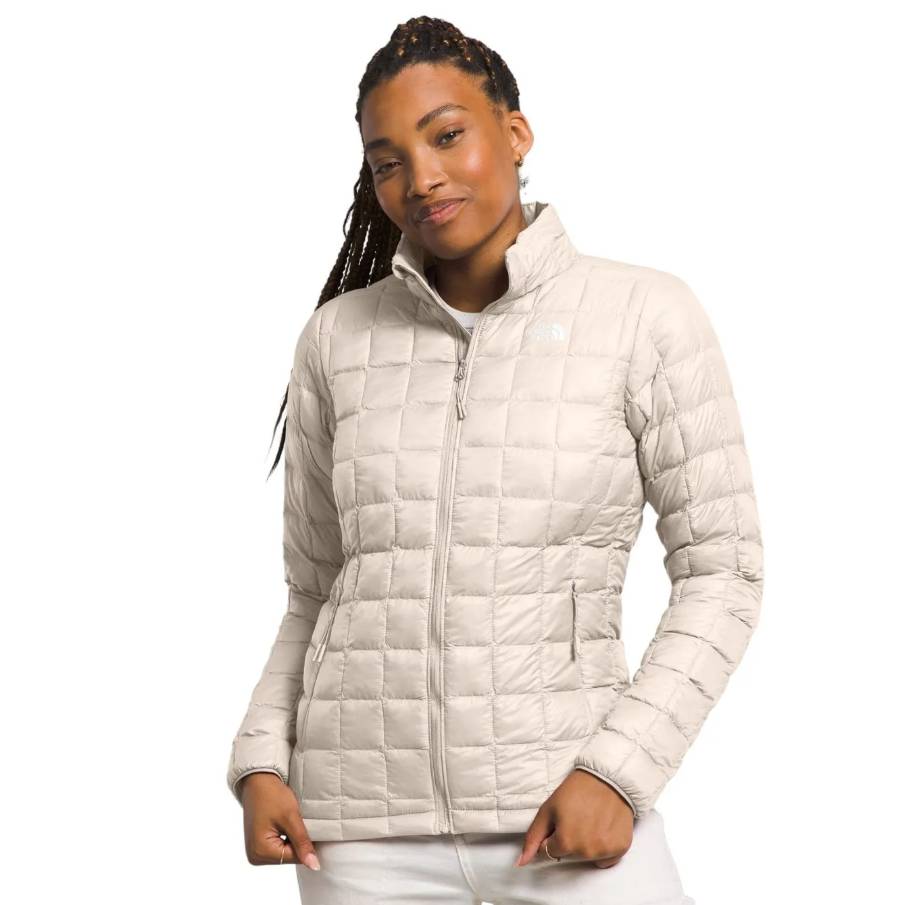 The North Face Thermoball Eco Jacket 2.0 is a lightweight, beige, quilted jacket designed for warmth and versatility, featuring a full front zip and side pockets.