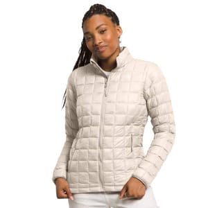 The North Face Thermoball Eco Jacket 2.0 is a lightweight, beige, quilted jacket designed for warmth and versatility, featuring a full front zip and side pockets.