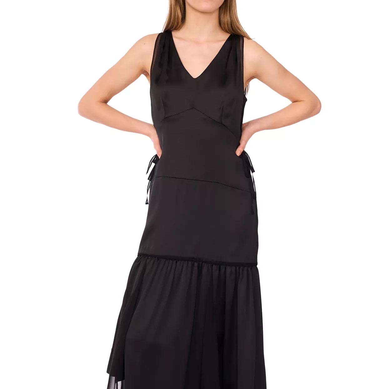 Sleeveless black dress with a V-neckline and a layered skirt. The design features side ties and a flowing silhouette.