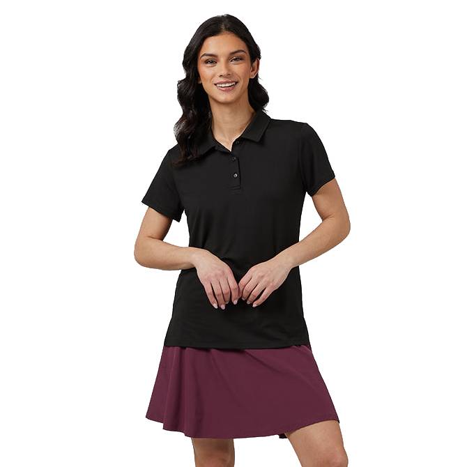 A woman is wearing a short-sleeved black polo shirt paired with a maroon skirt.