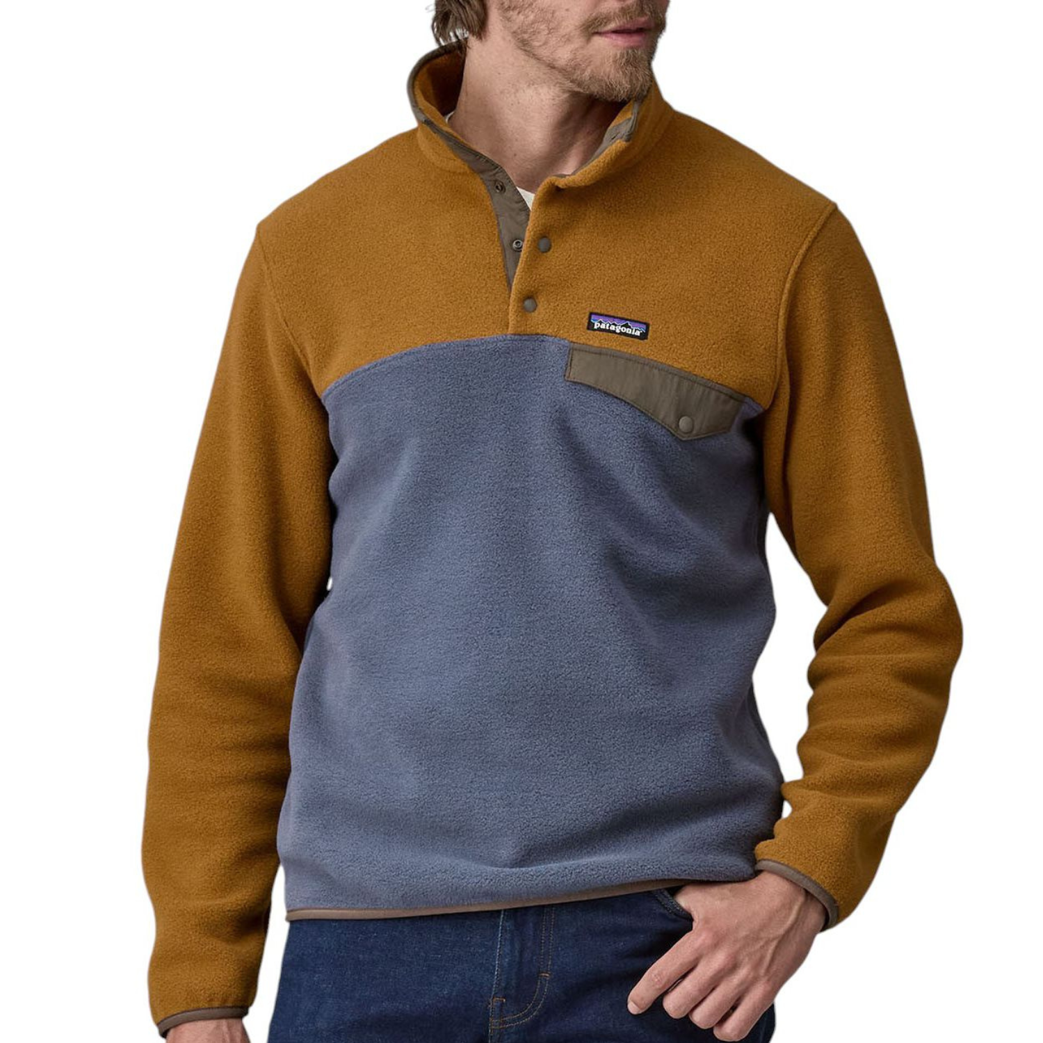 A Patagonia Synchilla Fleece Pullover in brown and gray features a snap-button chest placket, a high collar, and a chest pocket with a flap. The cozy fleece design is color-blocked with contrasting shoulder and body panels.