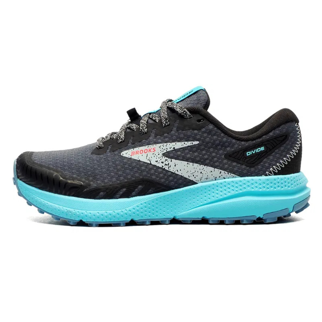A Brooks Divide running shoe featuring a black mesh upper, light blue sole, and speckled white design on the sides with gray laces.