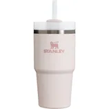 A Stanley tumbler in light pink with a lid, straw, and stainless steel band near the top edge.