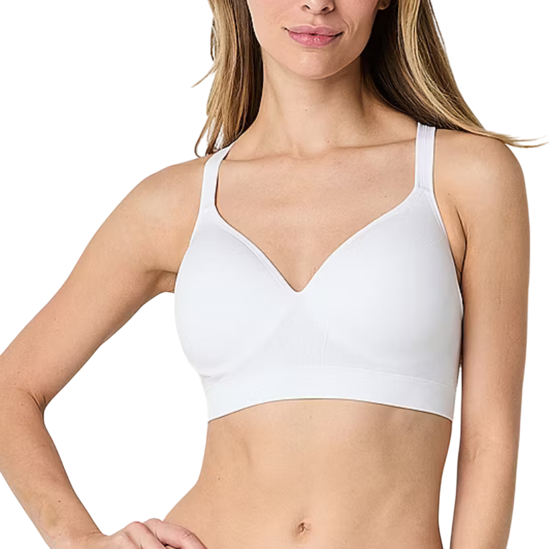A woman is wearing a white, seamless, wireless bra with wide straps, suitable for comfortable everyday wear.