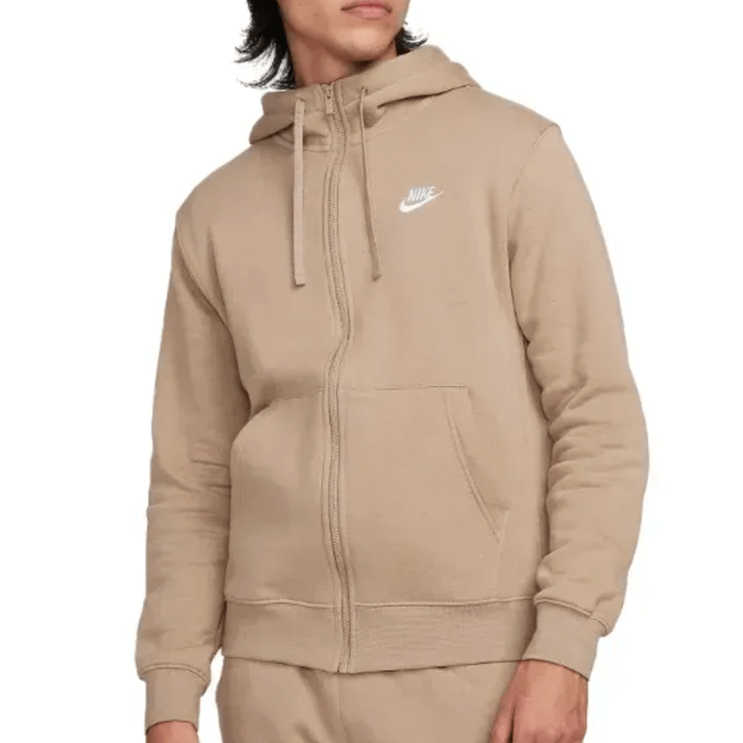 A beige Nike zip-up hoodie featuring a drawstring hood, front pockets, and a small white Nike logo on the chest.