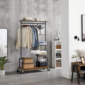 Open wardrobe with shelves and a clothes rail on wheels, alongside a tall, narrow white shelving unit.