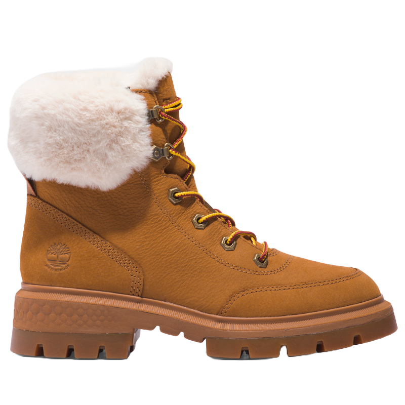 Timberland Women's Hiker Boots feature a tan leather exterior with a plush white fur collar, rugged brown rubber sole, and metal eyelets with yellow and red laces, offering a blend of style and durability for cold weather.