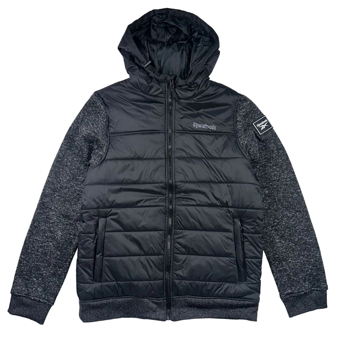 Black Reebok jacket with a padded body, hood, and textured gray sleeves. Features a front zipper, side pockets, and Reebok branding on the chest and sleeve patch.