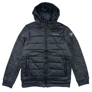 Black Reebok jacket with a padded body, hood, and textured gray sleeves. Features a front zipper, side pockets, and Reebok branding on the chest and sleeve patch.