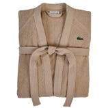 A beige Lacoste bathrobe with a belt and the brand's crocodile logo on the chest.