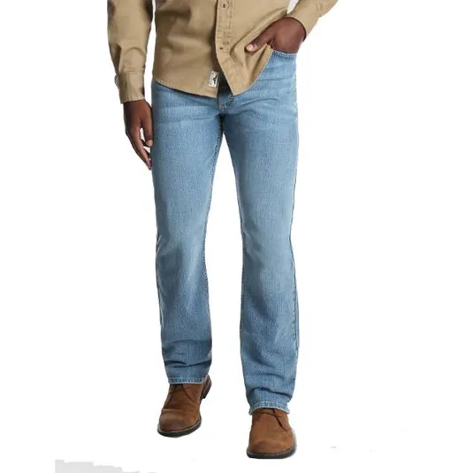 A person is wearing light blue jeans with a straight leg cut, paired with brown ankle boots and a tan button-up shirt.