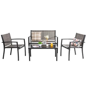 A 4-piece patio conversation set includes a loveseat, two armchairs, and a glass-top coffee table, featuring a sleek metal frame with mesh seating and backrests, accompanied by decorative cushions.