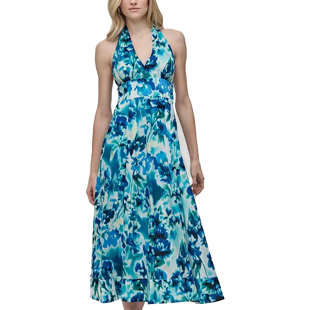 A woman is wearing a blue and white floral maxi dress with a halter neckline and a fitted waist.