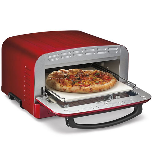 A red countertop pizza oven with a front opening displays a cooked pizza on a stone tray.