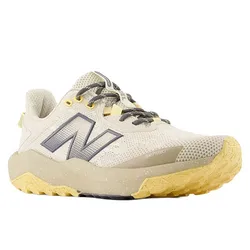 Trail running shoe with beige mesh upper, gray and yellow accents, rugged sole, and New Balance logo.
