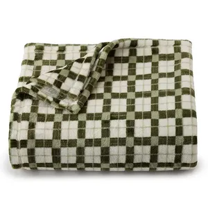 A folded, soft blanket with a green and white checkered pattern.